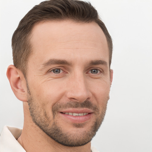 Joyful white adult male with short  brown hair and brown eyes