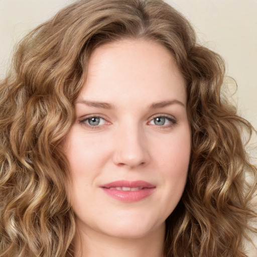 Joyful white young-adult female with long  brown hair and green eyes