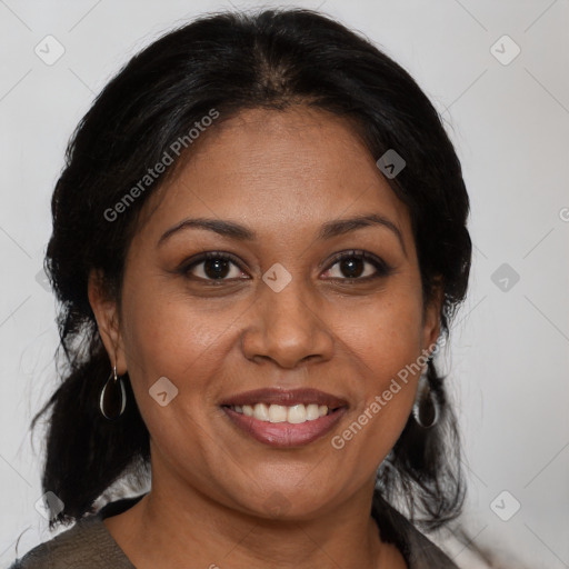 Joyful black adult female with medium  brown hair and brown eyes