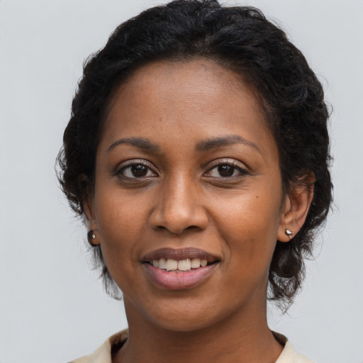 Joyful black young-adult female with medium  brown hair and brown eyes