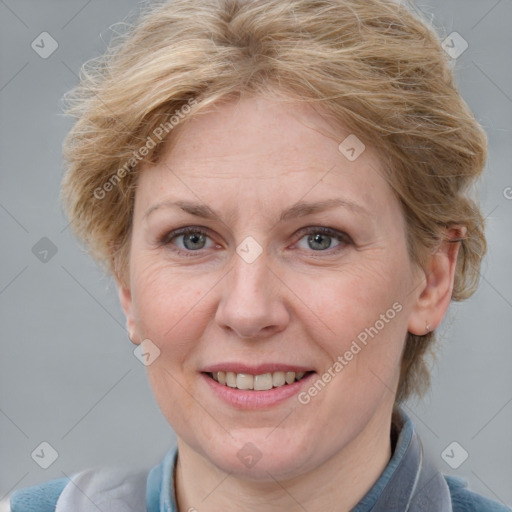 Joyful white adult female with medium  brown hair and blue eyes