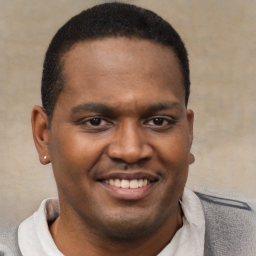 Joyful latino young-adult male with short  brown hair and brown eyes
