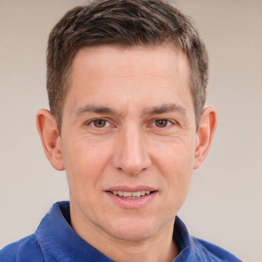 Joyful white adult male with short  brown hair and grey eyes