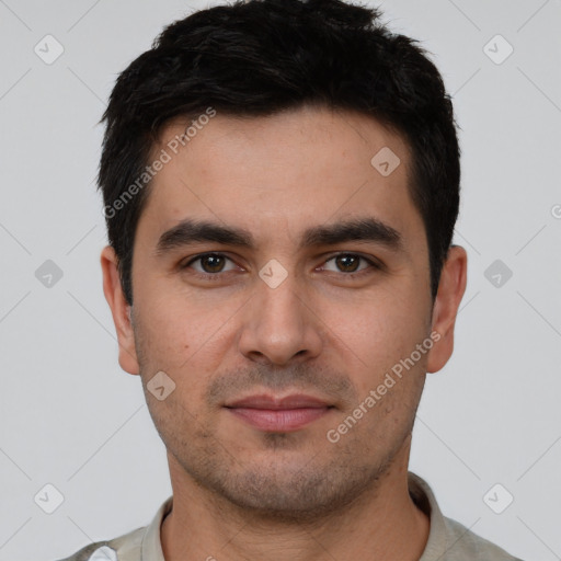 Joyful white young-adult male with short  black hair and brown eyes