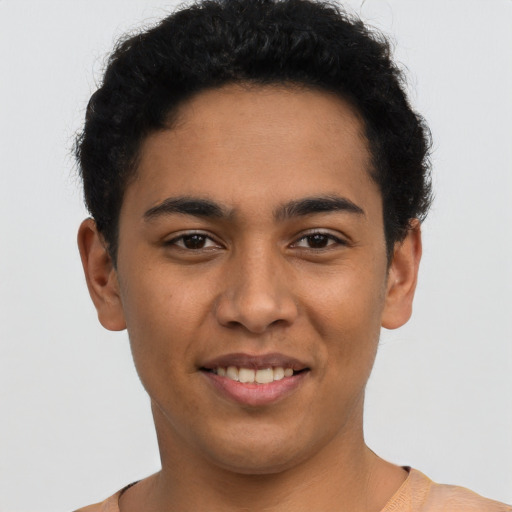 Joyful latino young-adult male with short  brown hair and brown eyes