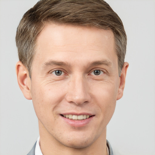 Joyful white adult male with short  brown hair and grey eyes