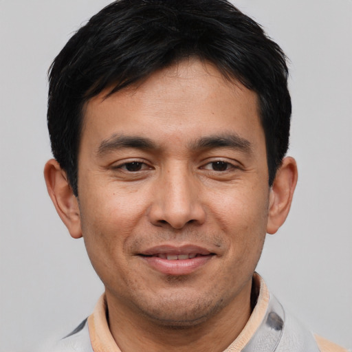 Joyful asian young-adult male with short  black hair and brown eyes