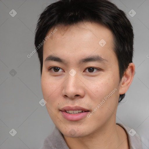 Joyful asian young-adult male with short  brown hair and brown eyes