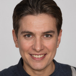 Joyful white adult male with short  brown hair and brown eyes