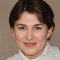 Joyful white adult female with medium  brown hair and brown eyes