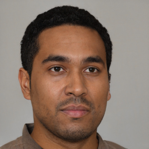 Neutral latino young-adult male with short  brown hair and brown eyes