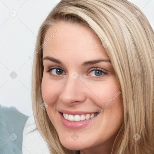 Joyful white young-adult female with long  brown hair and blue eyes