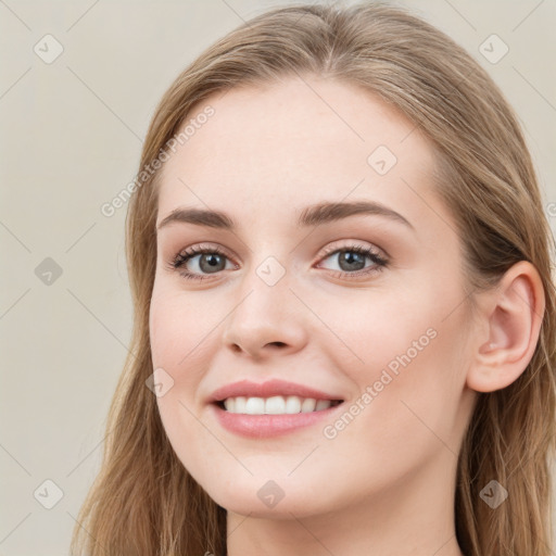 Joyful white young-adult female with long  brown hair and blue eyes