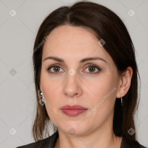 Joyful white adult female with long  brown hair and grey eyes