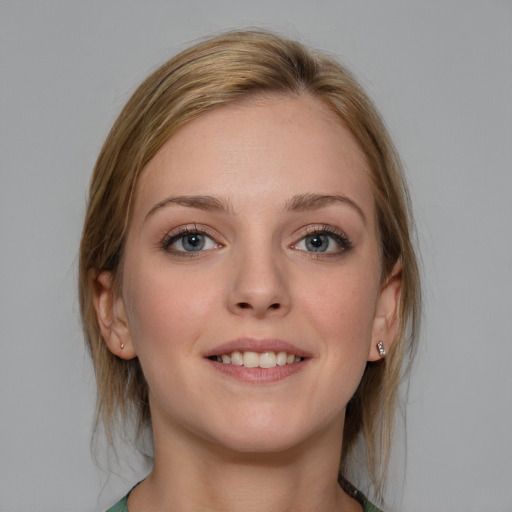 Joyful white young-adult female with medium  brown hair and blue eyes