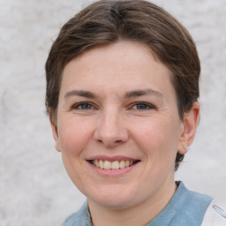 Joyful white adult female with short  brown hair and grey eyes