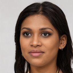 Joyful latino young-adult female with long  brown hair and brown eyes