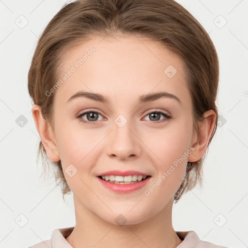 Joyful white young-adult female with medium  brown hair and grey eyes