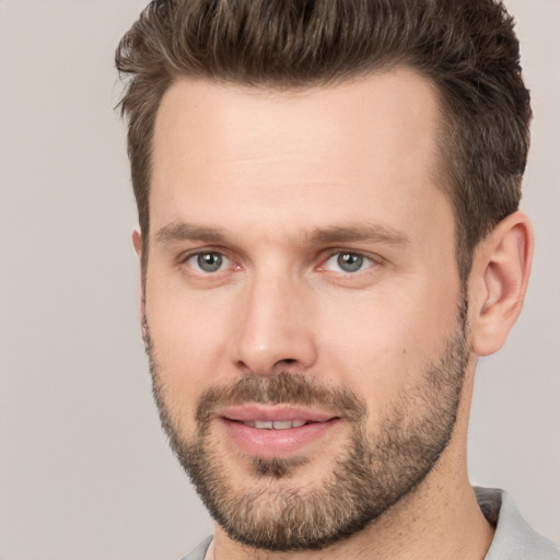 Joyful white young-adult male with short  brown hair and brown eyes