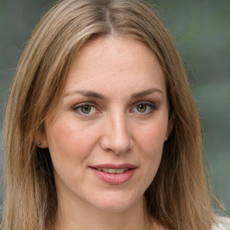 Joyful white young-adult female with long  brown hair and green eyes