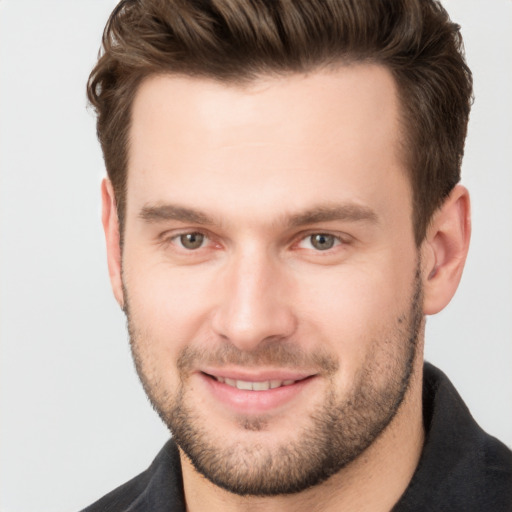 Joyful white young-adult male with short  brown hair and brown eyes