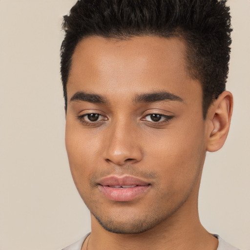 Joyful latino young-adult male with short  brown hair and brown eyes