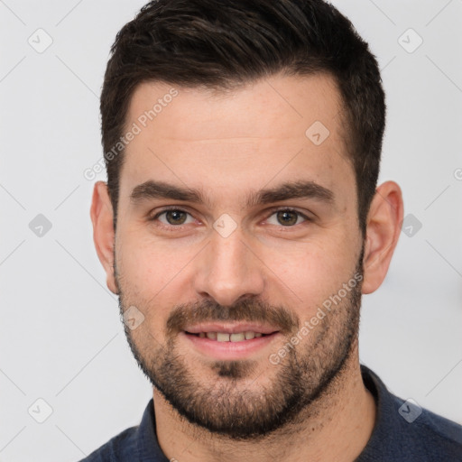 Joyful white young-adult male with short  brown hair and brown eyes