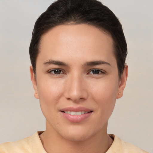 Joyful white young-adult female with short  brown hair and brown eyes