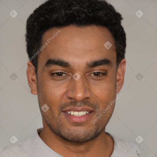 Joyful black young-adult male with short  black hair and brown eyes