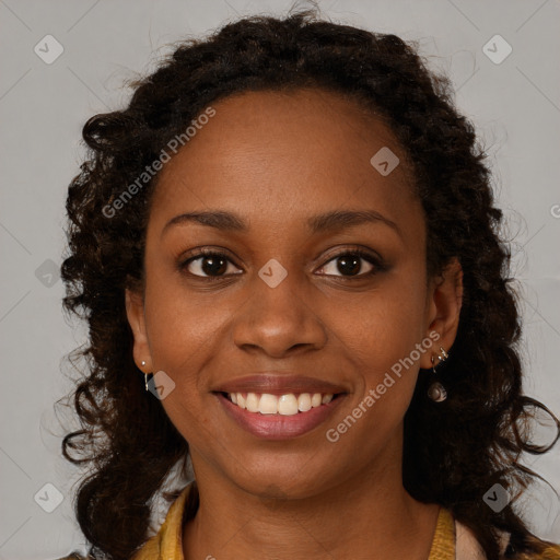 Joyful black young-adult female with long  brown hair and brown eyes