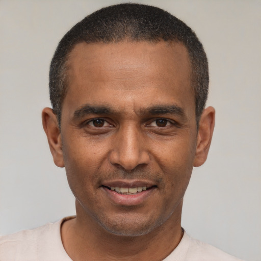 Joyful latino adult male with short  black hair and brown eyes