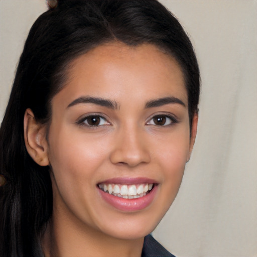 Joyful latino young-adult female with long  black hair and brown eyes