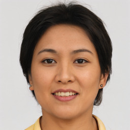 Joyful asian young-adult female with medium  brown hair and brown eyes