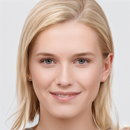 Joyful white young-adult female with long  brown hair and blue eyes