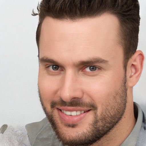 Joyful white young-adult male with short  brown hair and brown eyes