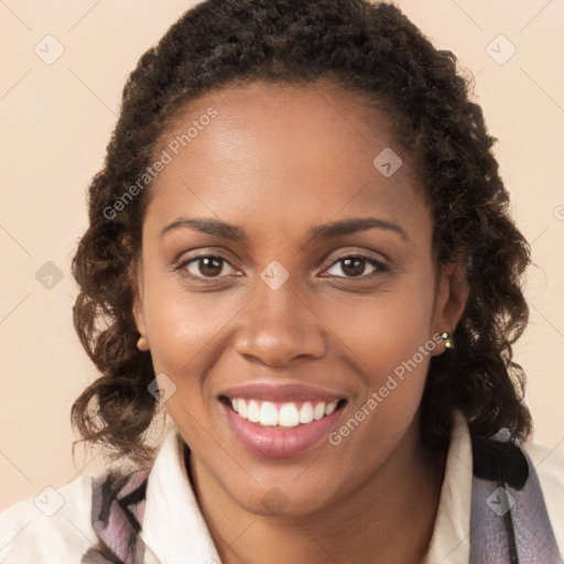 Joyful black young-adult female with long  brown hair and brown eyes