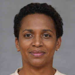 Joyful black adult female with short  brown hair and brown eyes