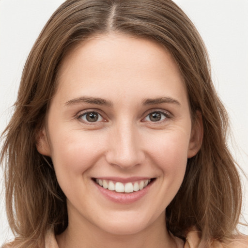 Joyful white young-adult female with long  brown hair and grey eyes