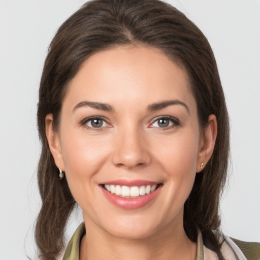 Joyful white young-adult female with medium  brown hair and brown eyes