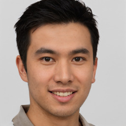 Joyful asian young-adult male with short  brown hair and brown eyes