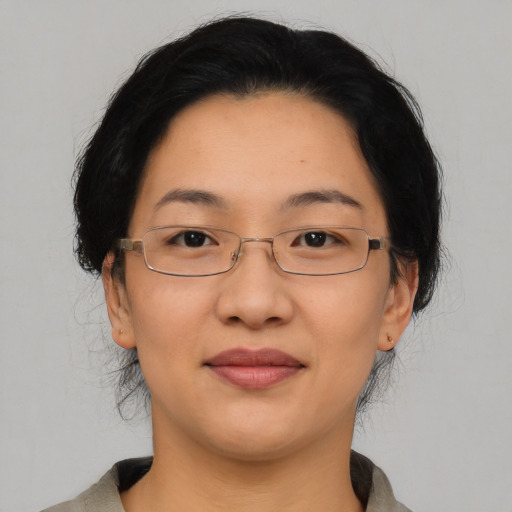 Joyful asian adult female with short  black hair and brown eyes