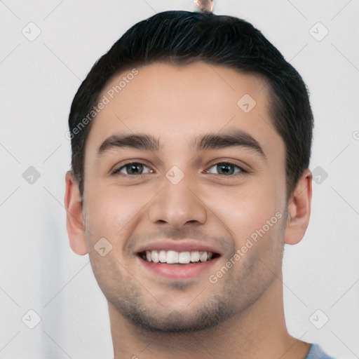 Joyful white young-adult male with short  black hair and brown eyes