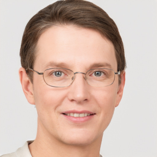 Joyful white adult male with short  brown hair and grey eyes