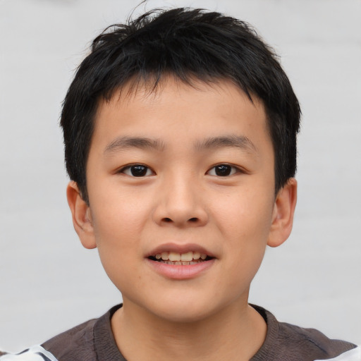 Joyful asian child male with short  brown hair and brown eyes