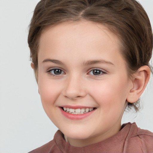 Joyful white child female with medium  brown hair and brown eyes