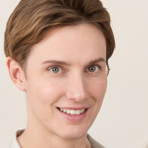 Joyful white young-adult female with short  brown hair and grey eyes