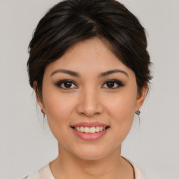 Joyful asian young-adult female with medium  brown hair and brown eyes