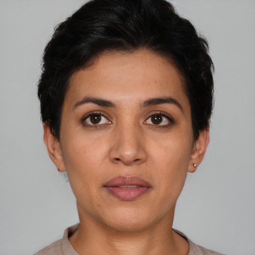 Joyful latino young-adult female with short  brown hair and brown eyes