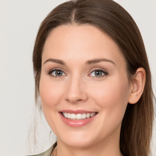 Joyful white young-adult female with long  brown hair and grey eyes