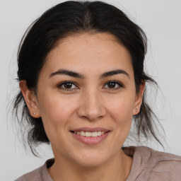 Joyful white young-adult female with medium  brown hair and brown eyes